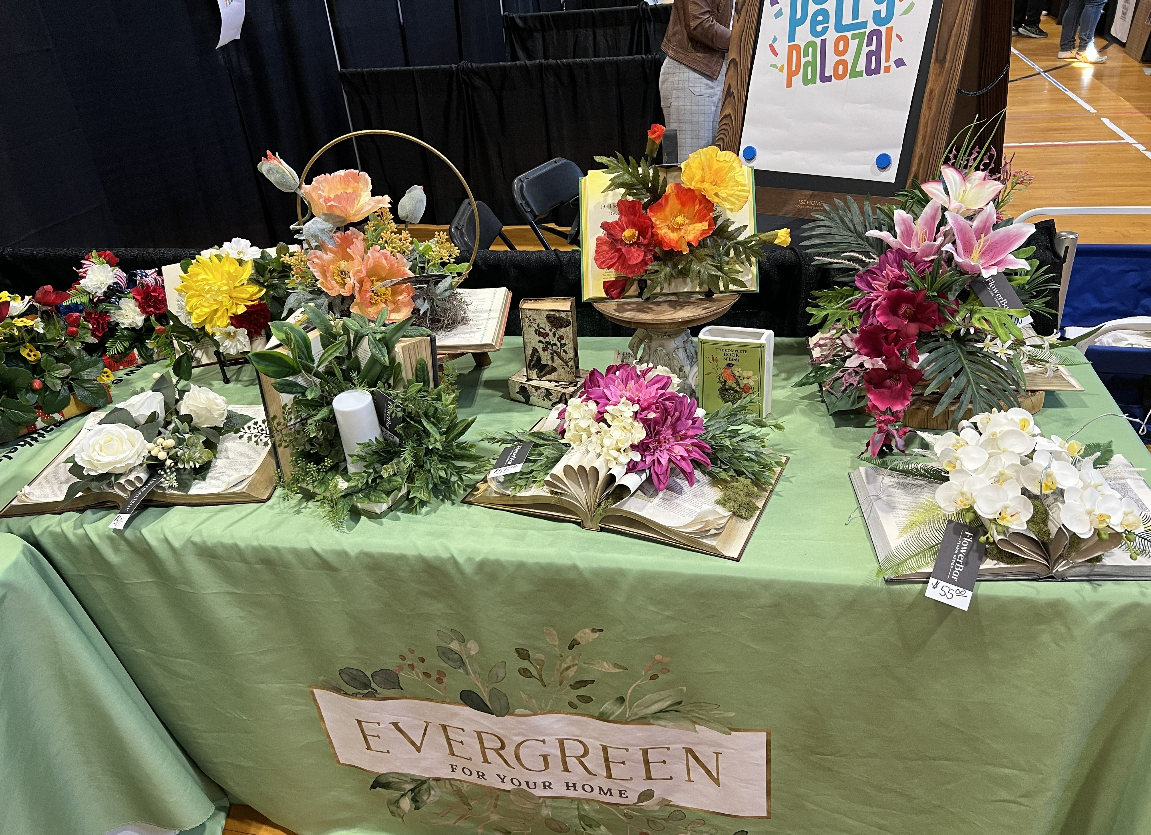 Evergreen floral arrangements designed with books
