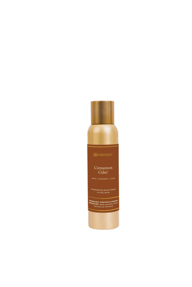 Aromatique Cinnamon Cider aerosol room spray bottle with a gold cap and brown label.