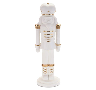 Nutcracker figurine, white resin with gold accents, 11 inches tall.