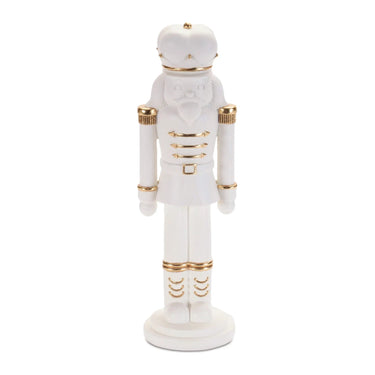 Nutcracker figurine, white resin with gold accents, 11 inches tall.