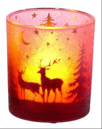Glass deer candle holder by Special T, pink translucent glass with deer and tree silhouettes, candle glow inside