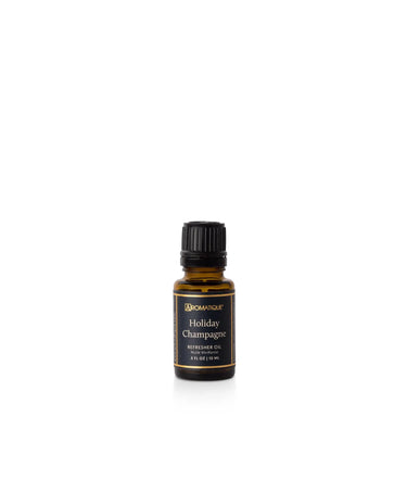 Aromatique Holiday Champagne fragrance oil refill in amber glass bottle with black label