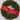 Ribbon banner in red with gold gilded Merry Christmas lettering, draped across a pine wreath.