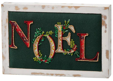Embellished wood Noel block on green fabric with beaded NOEL letters in a distressed white frame; Special T.