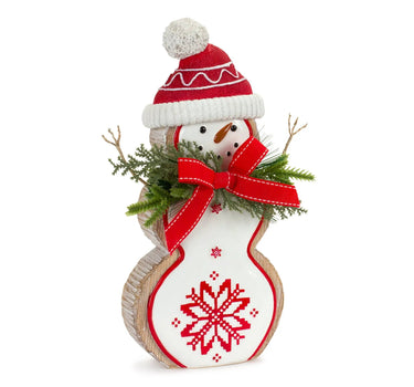 Resin snowman figurine with red knit hat, white pom-pom, white cuff, red scarf, snowflake motif, and greenery