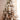Lit Snowy Wood Snowflake Lantern by Melrose on a snow-dusted Christmas tree with ornaments