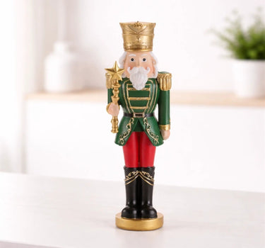 Resin green-red soldier nutcracker figurine, 7.75 in tall, green uniform with gold crown.