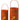 Metal cutout pumpkin can lanterns in two sizes, orange with handles, lit from inside.