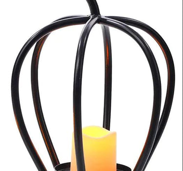Metal black ribbed pumpkin candle holder with candle inside