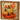 Beaded orange pumpkin block by Special T in a wooden frame, featuring two pumpkins with green stems and autumn leaves.