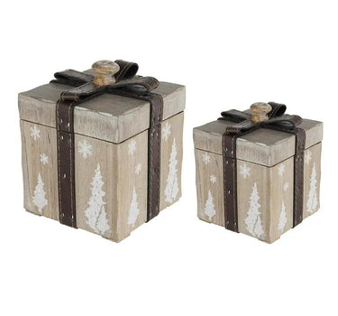 Two rustic wood decorative present boxes in two sizes, light brown with white snowflakes and trees, tied with dark brown ribbons.